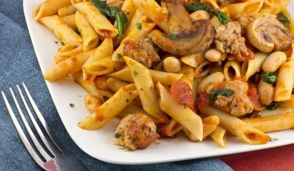 The Most Appetizing Pasta Is Prepared With Tomato Sauce, Sausages And Dried Mushrooms